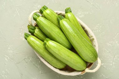 Gri arkaplanlı yeşil kabaklı sepet.