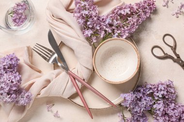Beyaz arka planda leylak çiçekleri olan güzel bir masa.