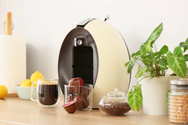 Mutfakta kapsüllü ve fasulyeli modern kahve makinesi.