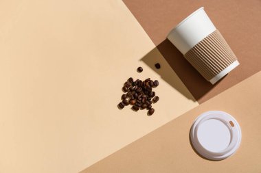 Kağıt bardak, kapak ve kahve çekirdekleri ile renklendirilmiş kompozisyon