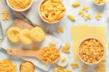 Açık arkaplanda farklı ham makarnayla kompozisyon