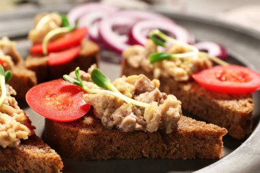 Gri arka planda morina ciğeri ve dolma biberli lezzetli sandviçler. Yakın plan.