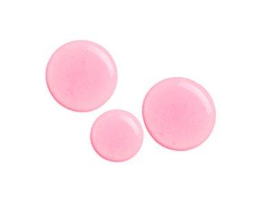 Beyaz arka planda pembe kozmetik yağ damlaları
