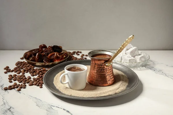 Bir fincan sıcak Türk kahvesi ve kum üzerinde beyaz arka plan