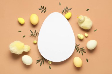 Yumurta şekilli boş kart, Paskalya yumurtaları, yavru tavuklar ve kahverengi arka planda yeşil yapraklar.