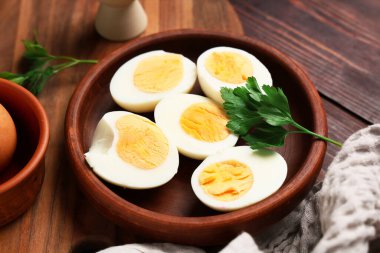 Ahşap arka planda haşlanmış yumurta tabağı, yakın plan.