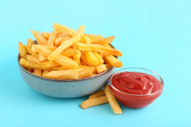 Lezzetli patates kızartması ve mavi arka planda ketçap.