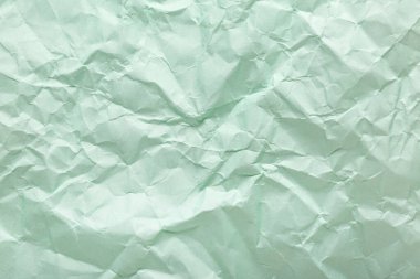 Arkaplan olarak yeşil buruşmuş kağıt yaprağı, üst görünüm