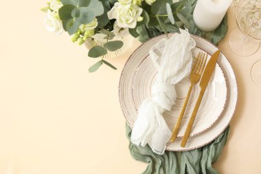 Düğün için şık masa seti. Arka planda altın çatal bıçak takımı.