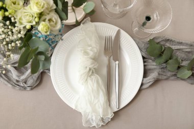 Gümüş çatal bıçakla düğün için şık bir masa.