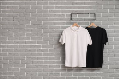 Gri duvarda asılı şık tişörtler