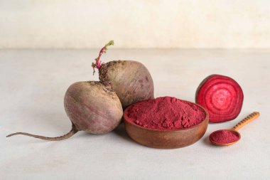 Tahta kase canlı pancar tozu ve beyaz arka planda taze pancar.