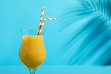 Kamış ve palmiye yaprağı arkaplanlı lezzetli bir kokteyl.