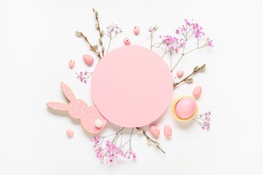 Composition with blank card, Easter eggs, flowers and pussy willow branches on white background