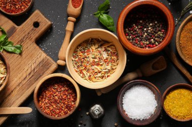 Koyu arkaplanda çeşitli taze baharatlar içeren kompozisyon