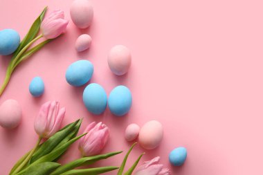 Pembe arka planda lale çiçekleriyle boyanmış Paskalya yumurtaları.