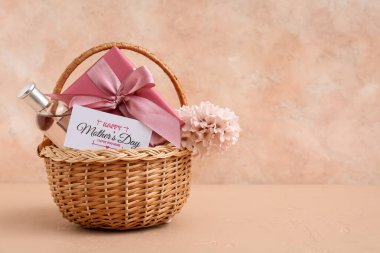 Çiçekli sepet, hediye kutusu ve Anneler Günü için parfüm. Bej rengi grunge arka planda.