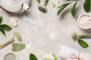 Arkaplanda spa aksesuarları, çaydanlık ve bitki dallarından yapılmış çerçeve