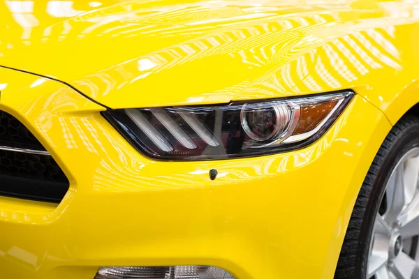 Part of front end of a yellow sport scar — Stock Photo, Image