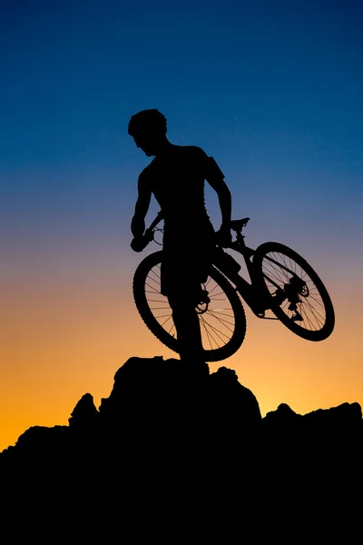 Mountain biker silhouette on the sunset — Stock Photo, Image