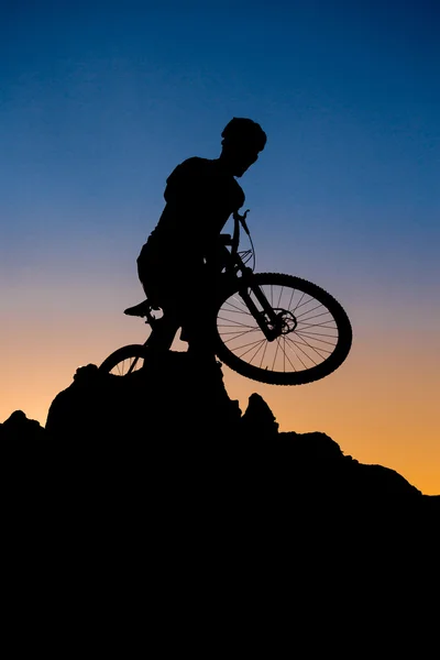 Mountain biker silhouette on the sunset — Stock Photo, Image