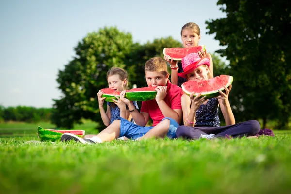 Cute children eating watermelon on a sunny day — Stock Photo, Image