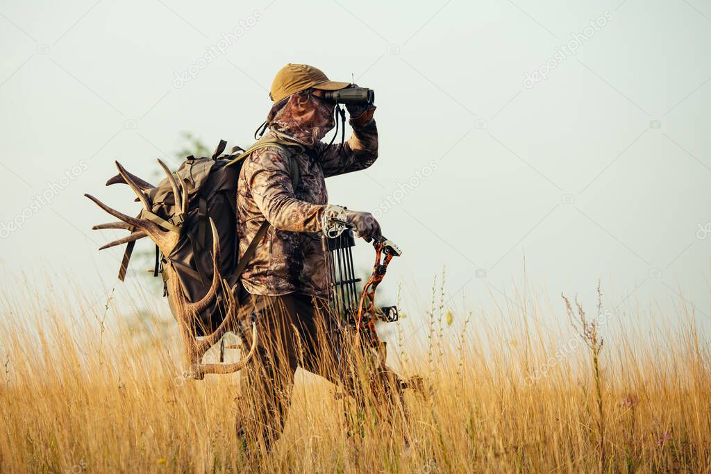 Archery hunter scouting for his next target.