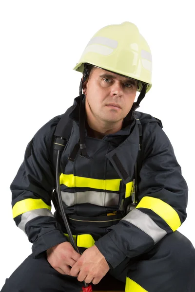 Brandweerman in uniform geïsoleerd in wit — Stockfoto