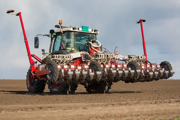 Tractor and seeder planting crops on a field — Stock Photo, Image