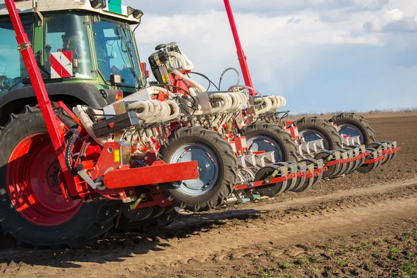 Tractor and seeder planting crops on a field — Stock Photo, Image