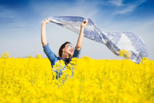 Young happy girl with a scarf in the field — Stock Photo, Image