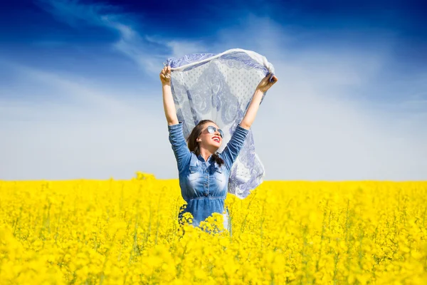 Young happy girl with a scarf in the field — Stock Photo, Image