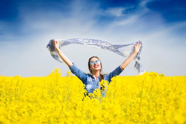 Young happy girl with a scarf in the field — Stock Photo, Image