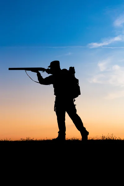Охотник с ружьем на закате — стоковое фото