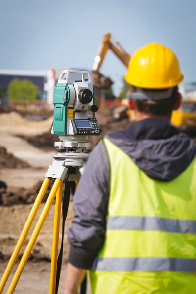 Surveyor engineer worker making measuring with theodolite tool equipment at construction site Stock Image