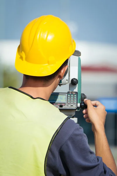 Surveyor engineers working with theodolite on road construction site — Stock Photo, Image