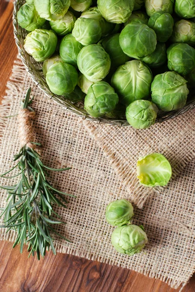 Fresh green broccoli over old wood table — Stock Photo, Image