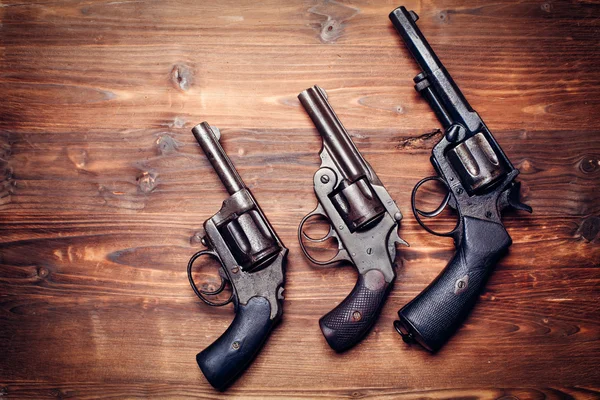 Vintage pistols on wooden background — Stock Photo, Image