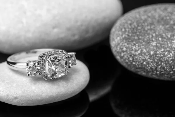 silver ring with diamond rings on a black background