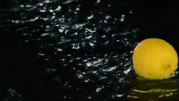 Closeup Fresh Lemons Splashing Water Black Background — Stock Video