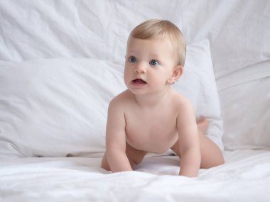 Cute caucasian baby girl in bed