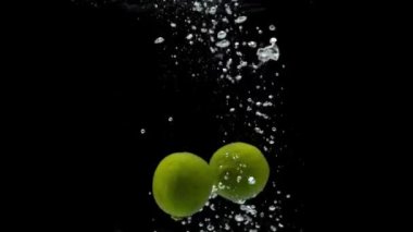 Siyah arkaplanda taze yeşil limon