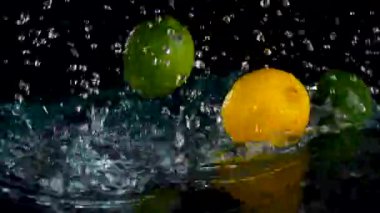 Taze limon ve limon yakın plan siyah zemin üzerinde süzülen su 