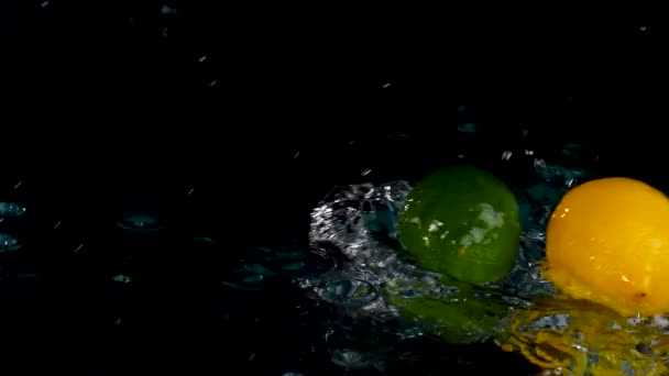 Closeup Fresh Lemons Limes Splashing Water Black Background — Stock Video