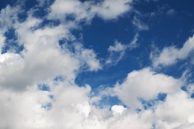 The sky is blue with a few clouds scattered throughout. The clouds are white and fluffy, giving the sky a peaceful and serene appearance