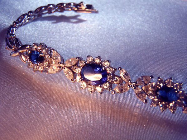 Silver bracelet with sapphires and cubic zirconias, macro.