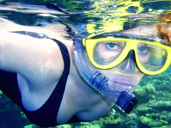 Flickan i en mask med en slang under vatten (snorkling). — Stockfoto