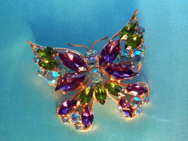 Beautiful butterfly brooch with multi-colored glass stones clipart