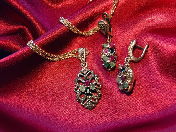 Silver earrings and suspension bracket on a chain, macro