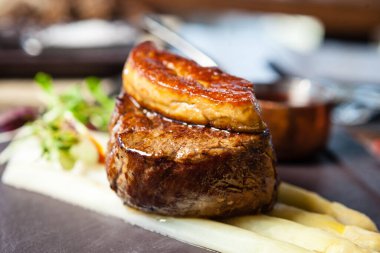 Tournedos Rossini. Foie gras, Black Angus sığır filetosu, beyaz kuşkonmaz, kırmızı şarap sosu. Modern gurme yemek restoranında öğle yemeği olarak sunulan lezzetli, sağlıklı geleneksel yemekler..